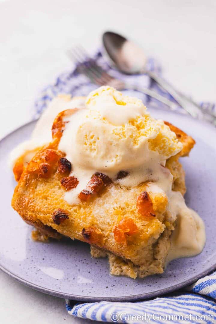 bread and butter pudding served with ice cream.
