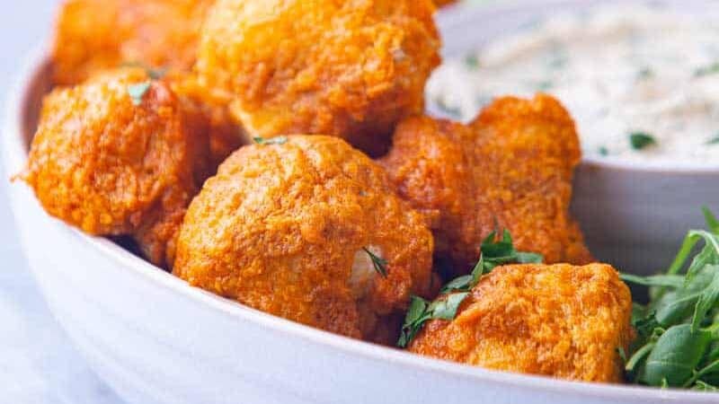 Bowl of orange buffalo cauliflower wings