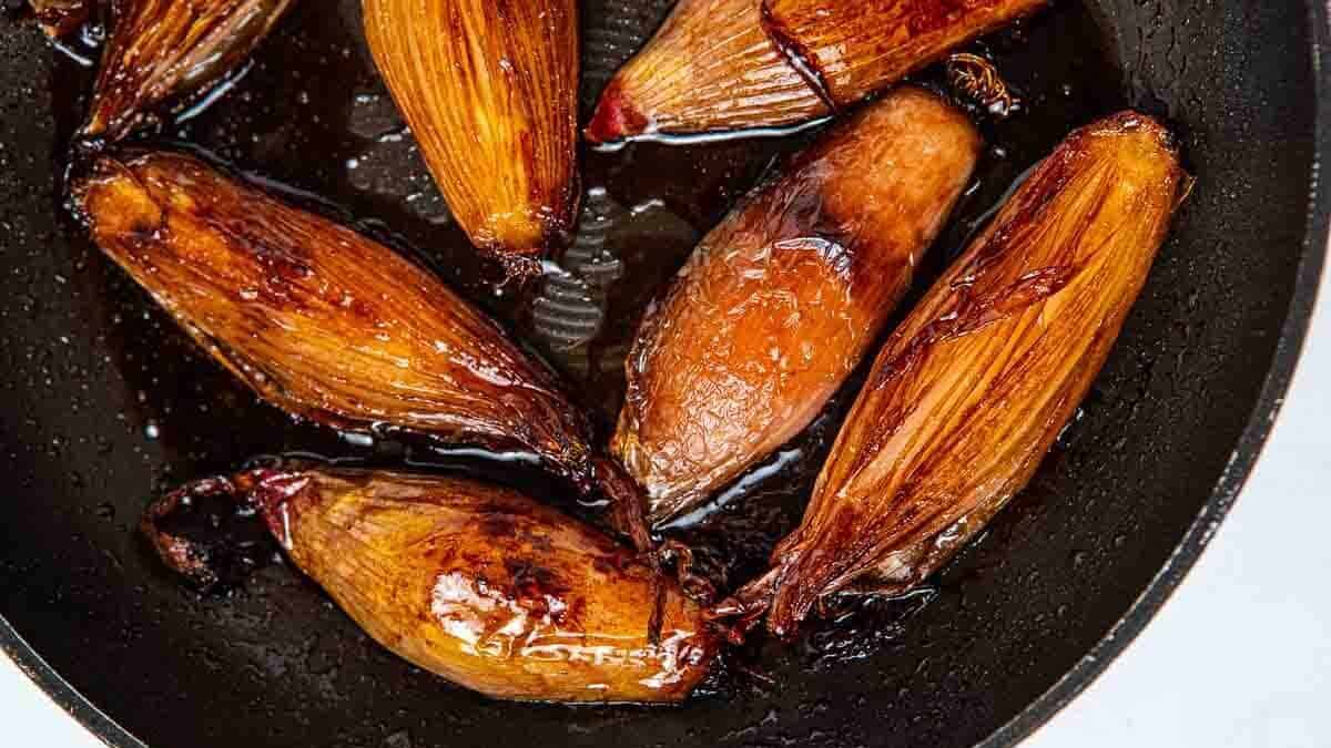 pan of shallots with sweet and tangy sauce