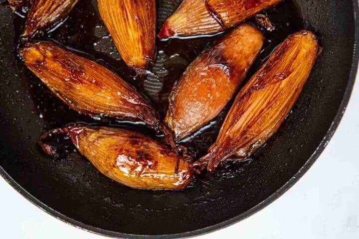 pan of shallots with sweet and tangy sauce