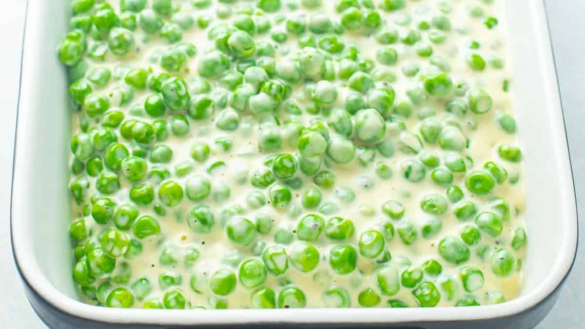 Baking dish full of a pea side dish