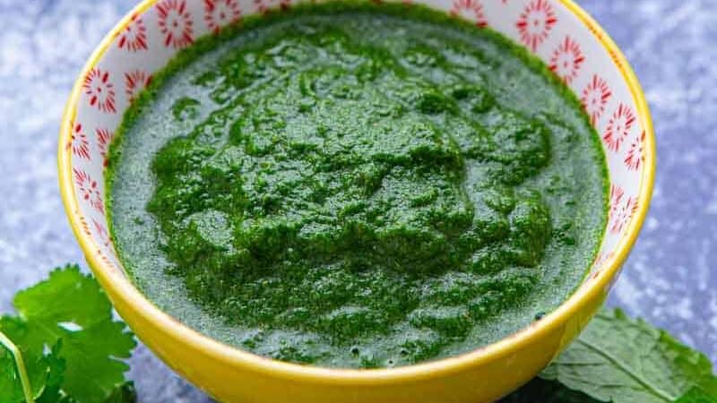 Bowl of bright green Indian sauce