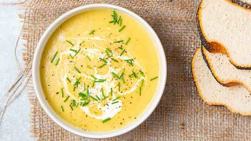 Two bowls of yellow leek and onion soup