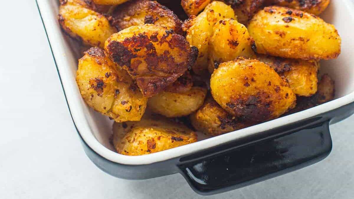 Large baking dish full of roast potato recipes