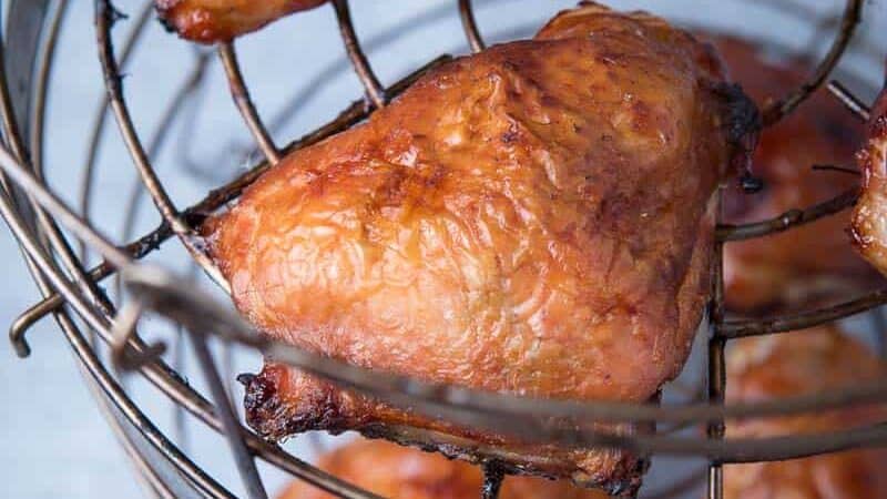 Chicken Thighs lined up on a smoker