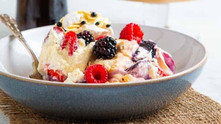 Bowl of a berry dessert and a bottle of Amarula