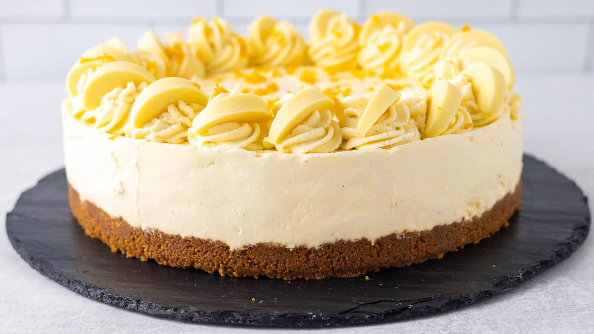 white chocolate orange cheesecake decorated with orange peel.