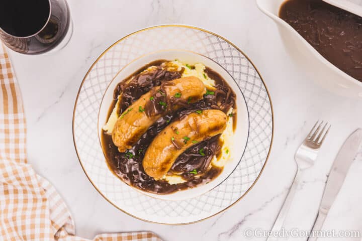 Onion gravy on top of mash and sausages.