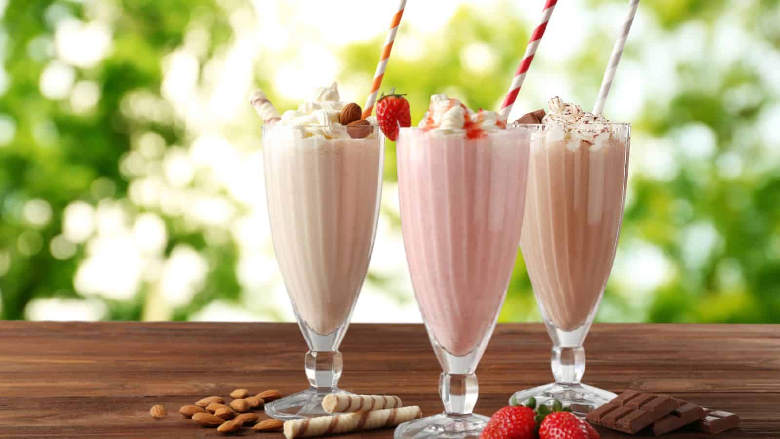 Milkshakes in a walnut, strawberry and chocolate flavor serve in a smoothies glass.