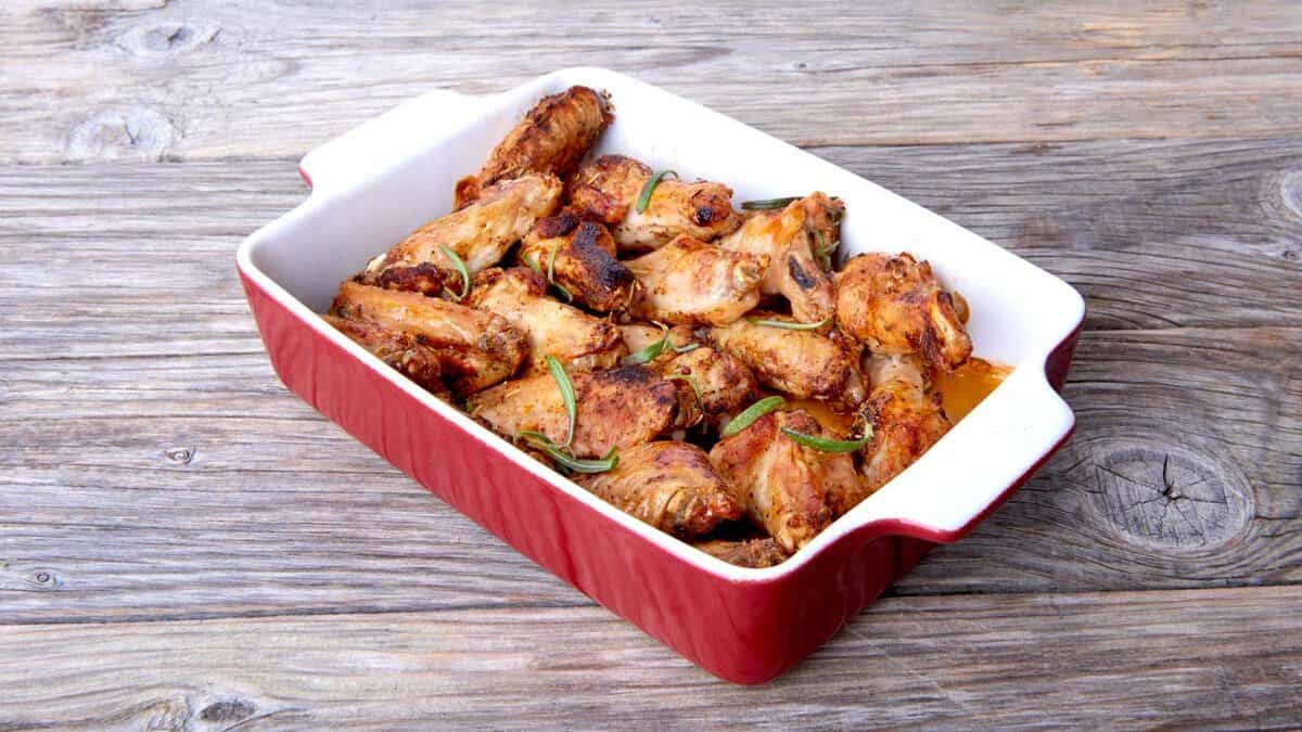 Chicken wings in bbq sauce in a casserole dish