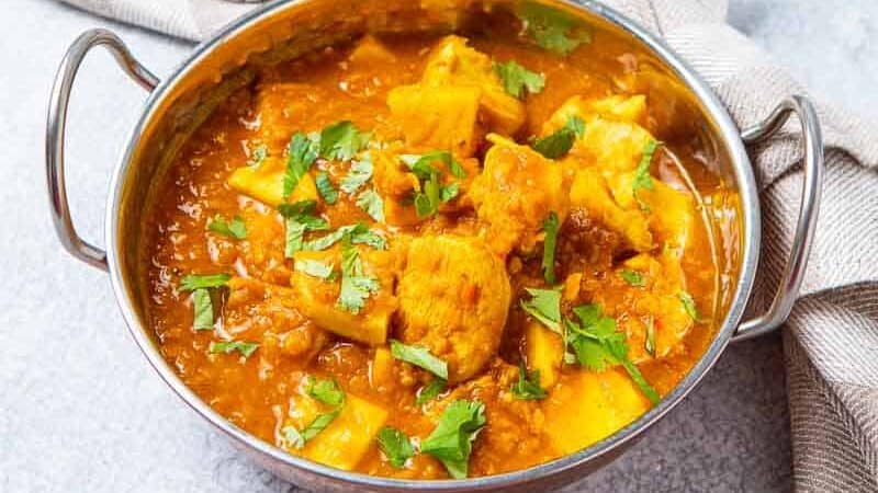 Bowl if Indian Chicken Curry with a bowl of nice