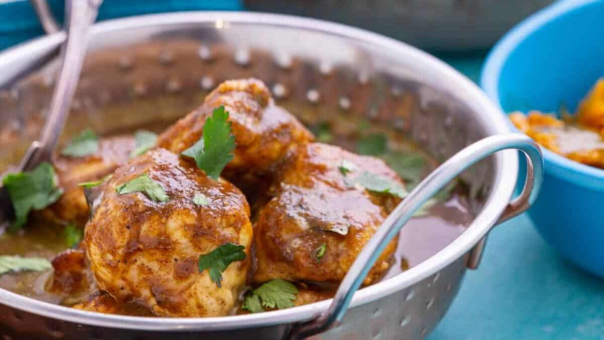 Bowl of monkfish curry and a bowl of yellow rice