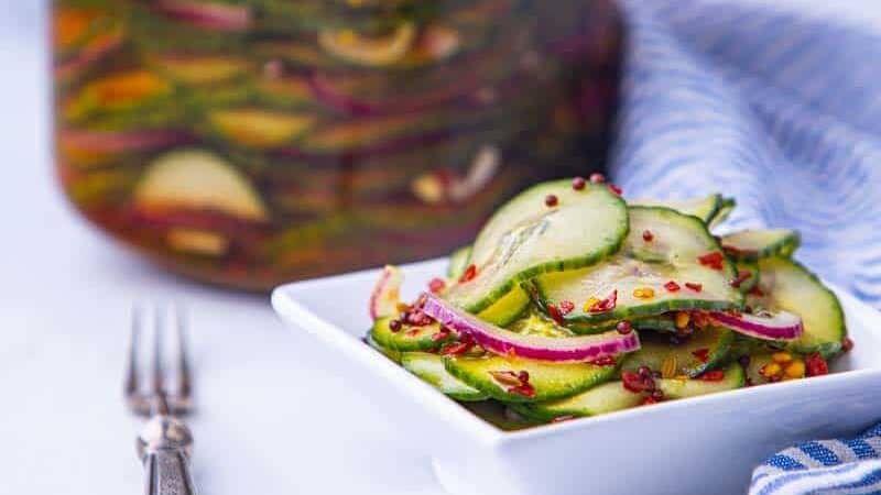 Pickled cucumbers in a plate with spices