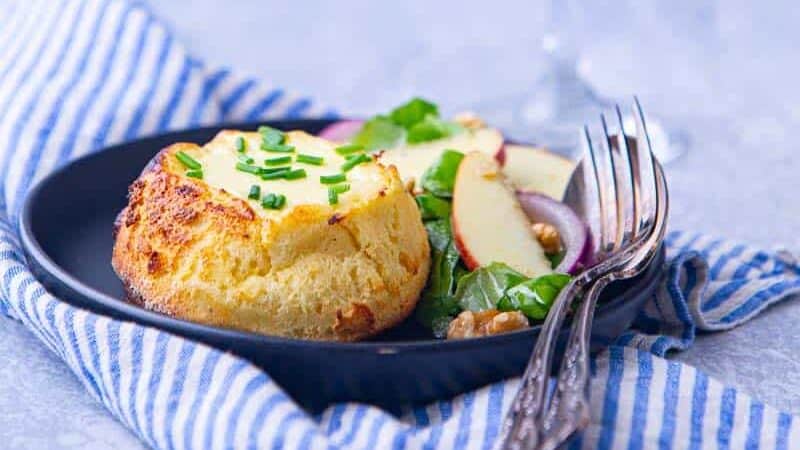 A plate of souffle recipe and a glass of white wine