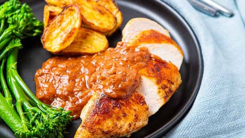 Plate of Chicken with Rhubarb Sauce and a side of potatoes and broccolini