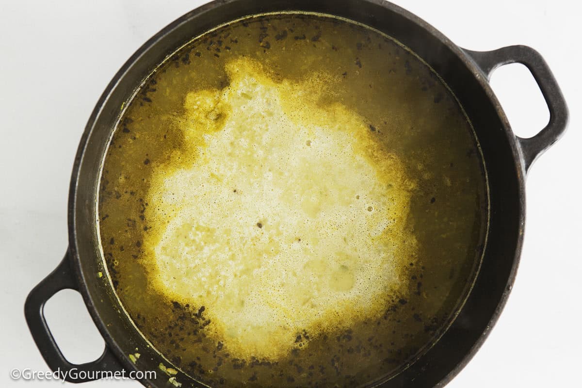 Cream added to a pot of chicken pot.