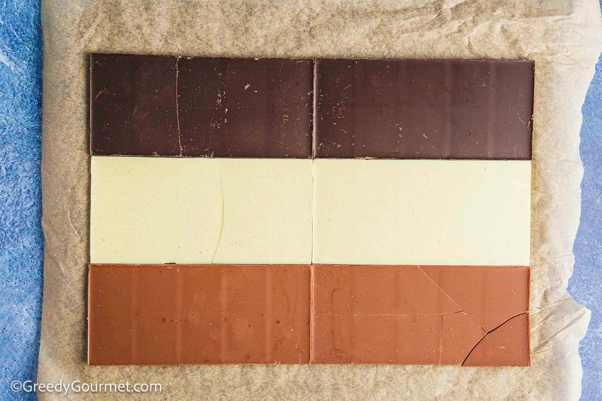 Slabs of chocolate laid out on a baking sheet.