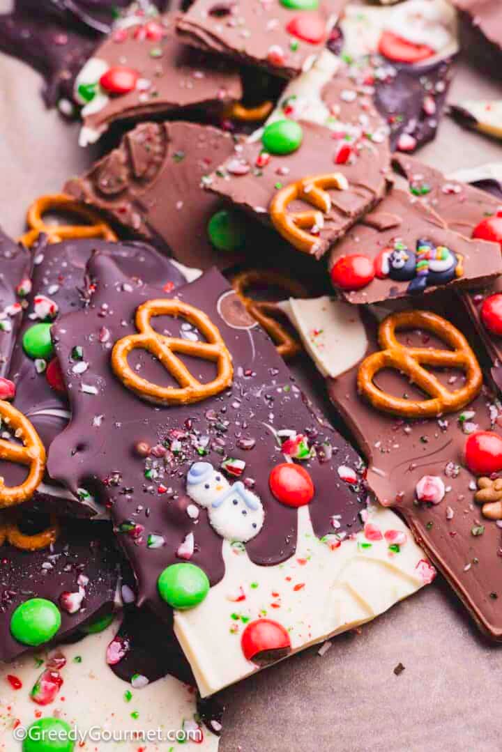 Closeup of Christmas bark, melted chocolate with pretzels and candy.