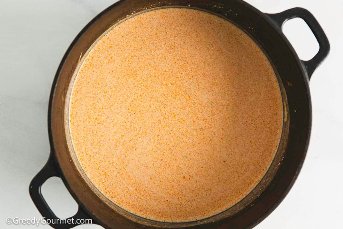 Warming up a cheese sauce.