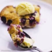 Blueberry cobbler slice with a scoop of ice cream.