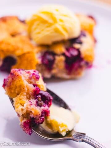 Blueberry cobbler slice with a scoop of ice cream.