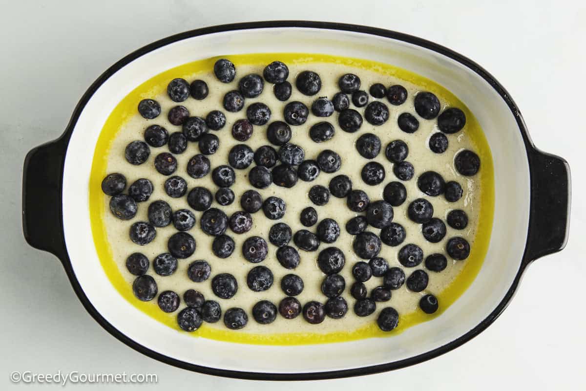 Unbaked blueberry cobbler in a casserole dish.