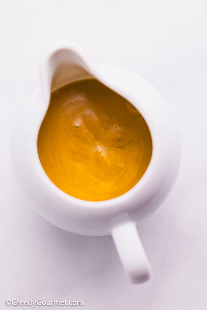 Greek salad dressing in a  sauce boat.