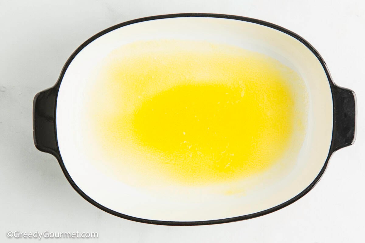 Melted butter in a casserole dish.