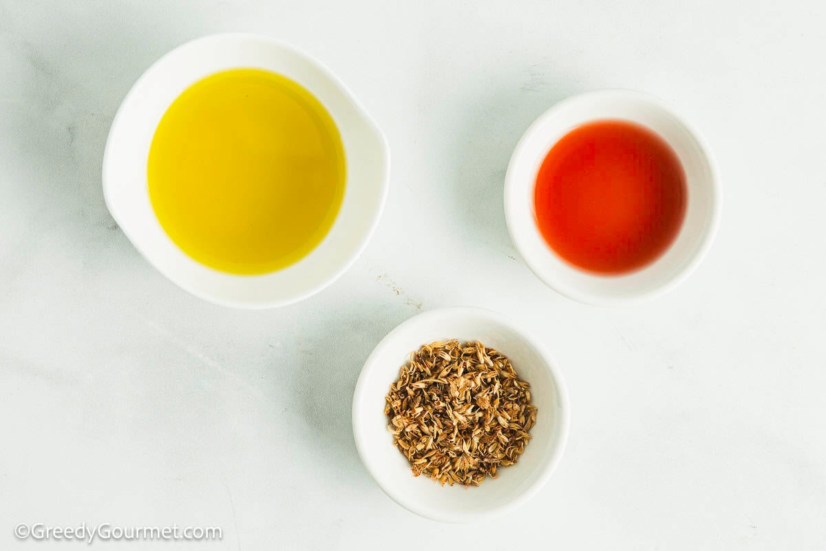 3 small bowls with olive oil, vinegar and oregano.