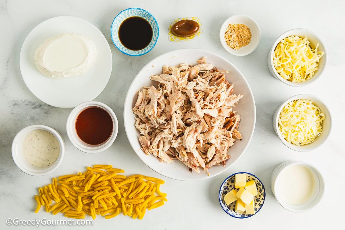 Ingredients for making buffalo chicken pasta on a table.