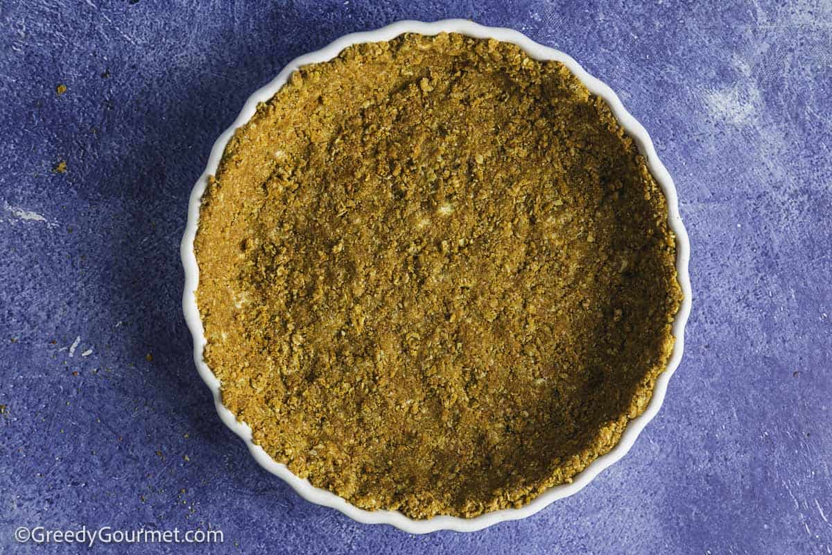 Pie base in a baking dish.