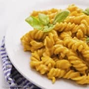 Slow cooker feta and tomato pasta served on a white plate.