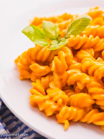Slow cooker feta and tomato pasta served on a white plate.