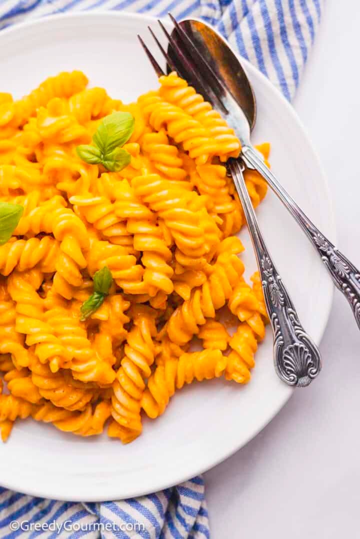 Slow cooker feta and tomato pasta served on a white plate.