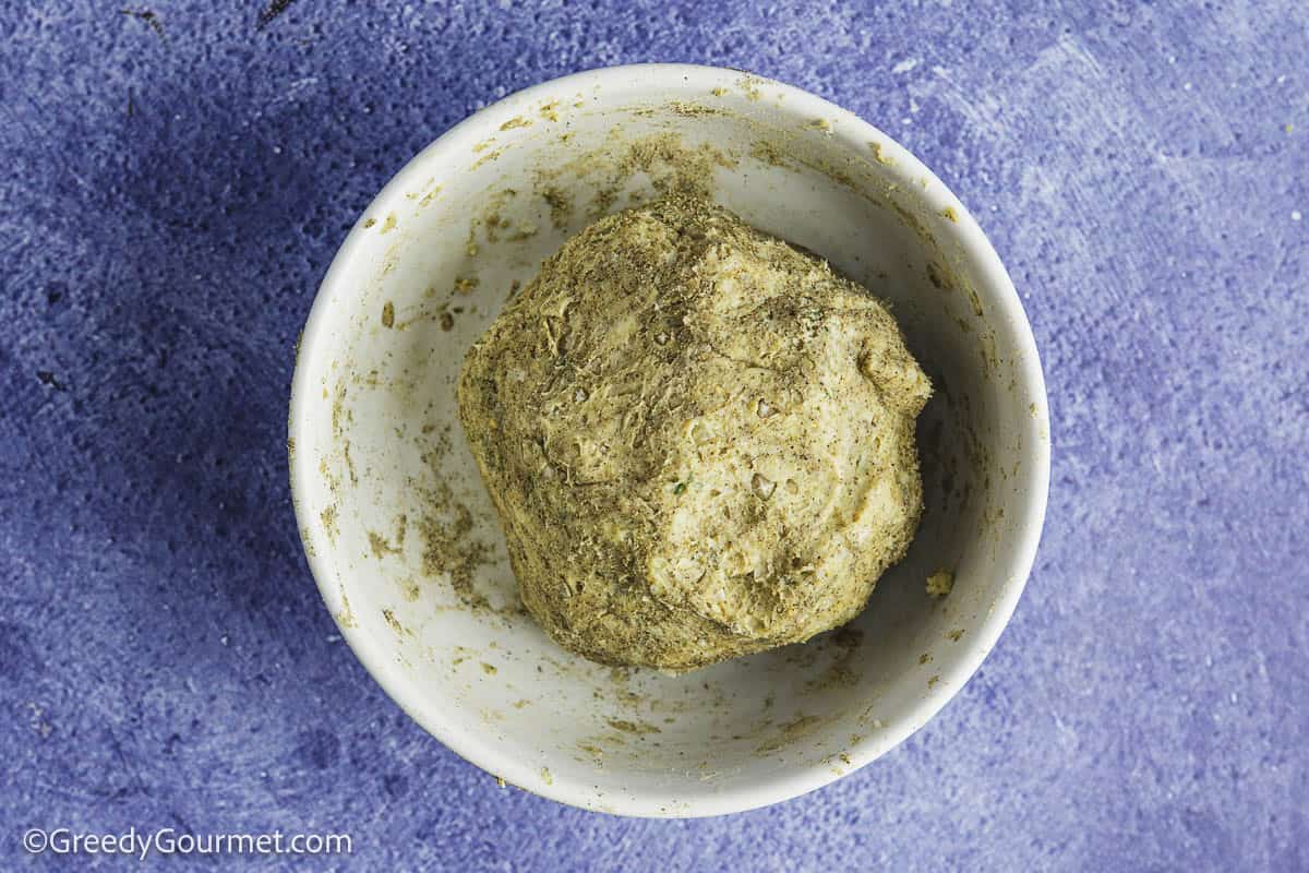 A ball of spiced butter in a white bowl.