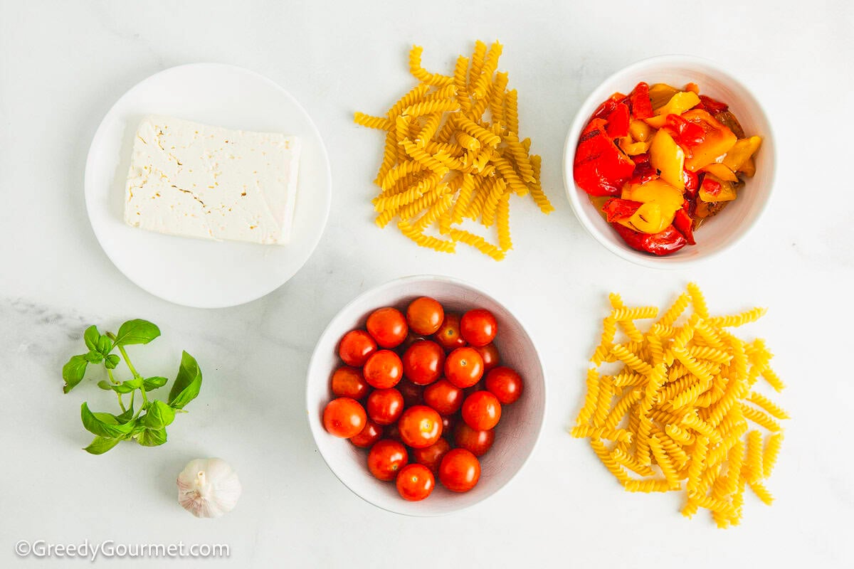 Ingredients for feta and tomato pasta on a table.